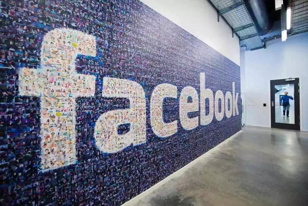 Facebook logo em parede de fotos